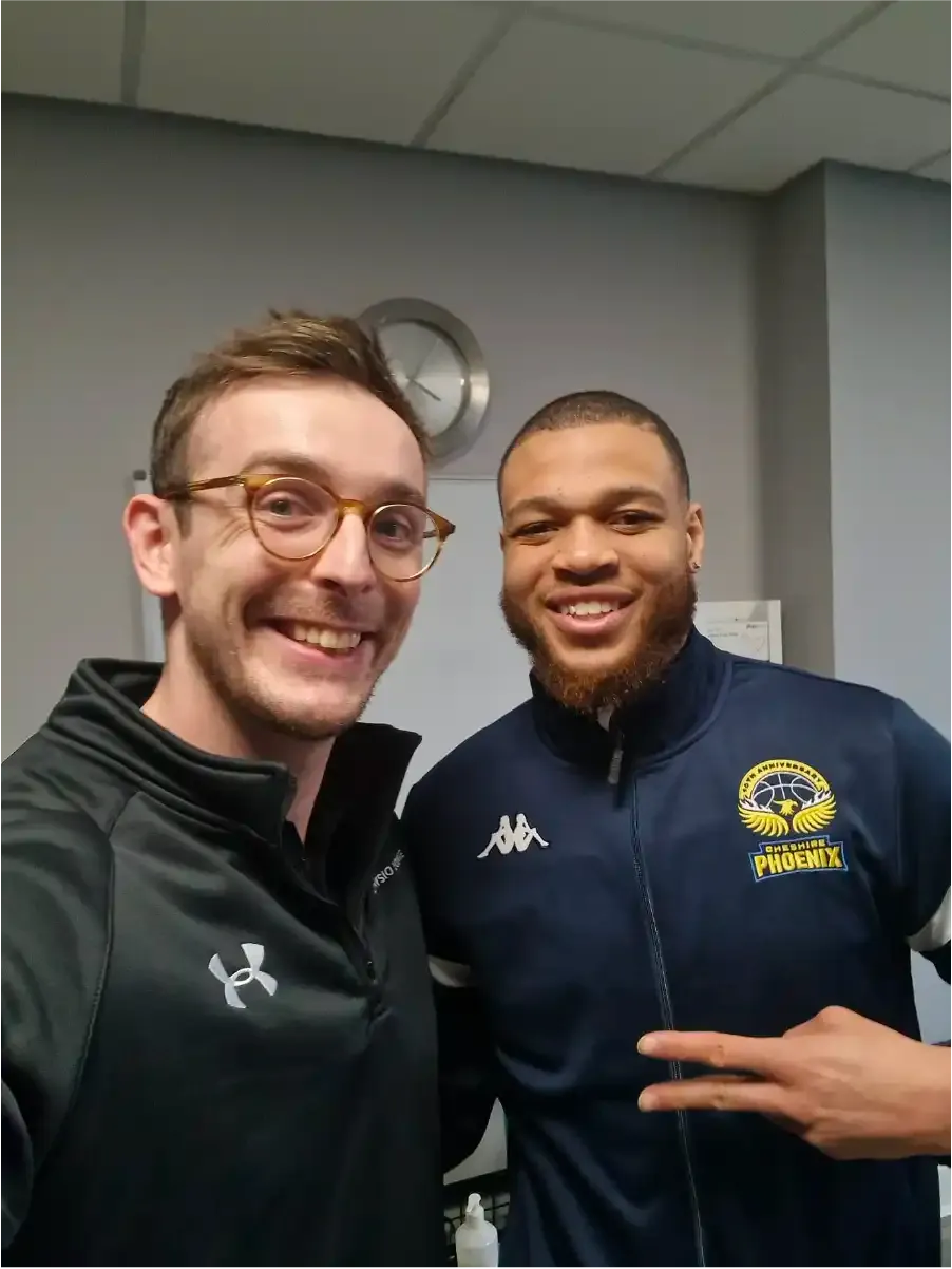 Client celebrating recovery with thumbs up gesture with physiotherapist