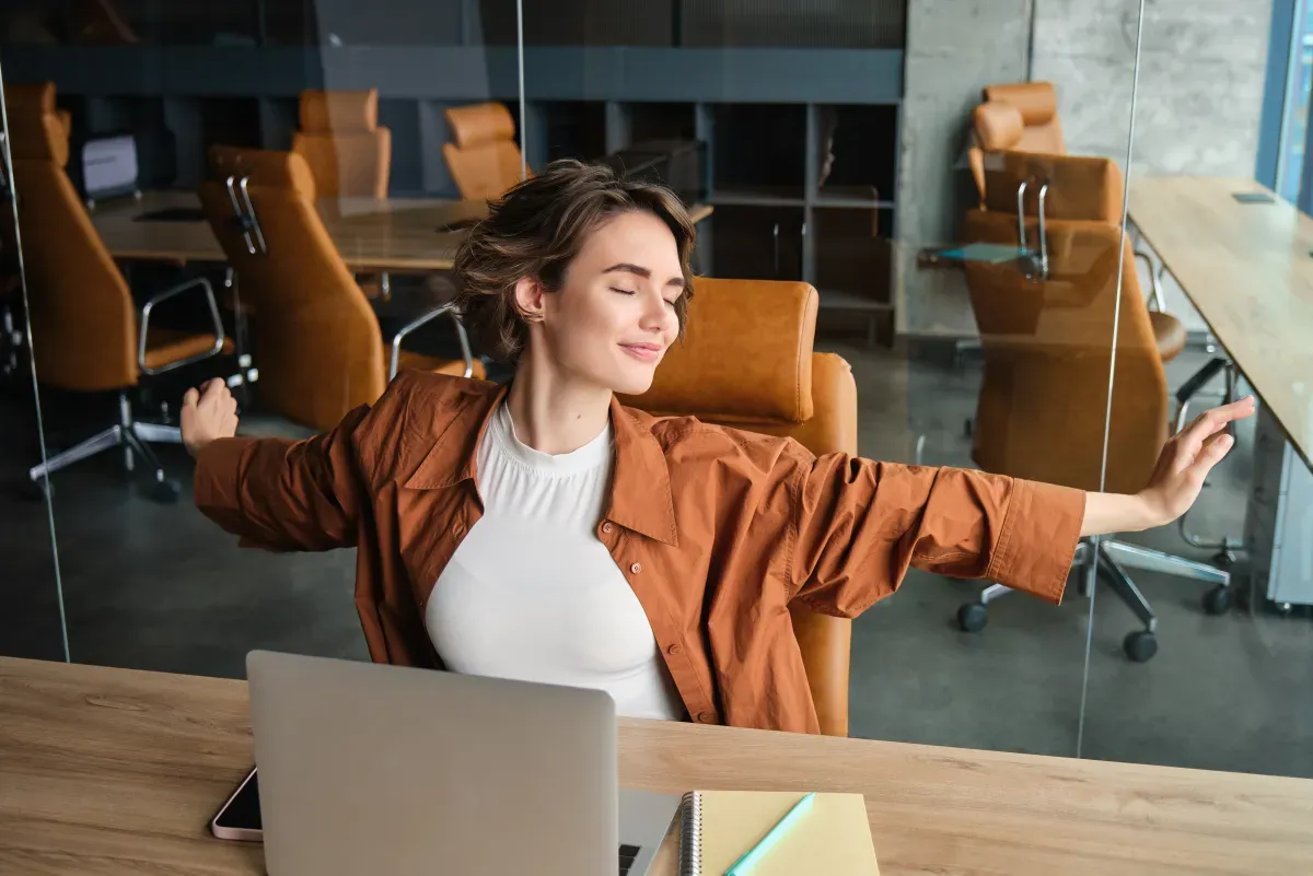 Office worker at a desk stretching their neck and shoulders