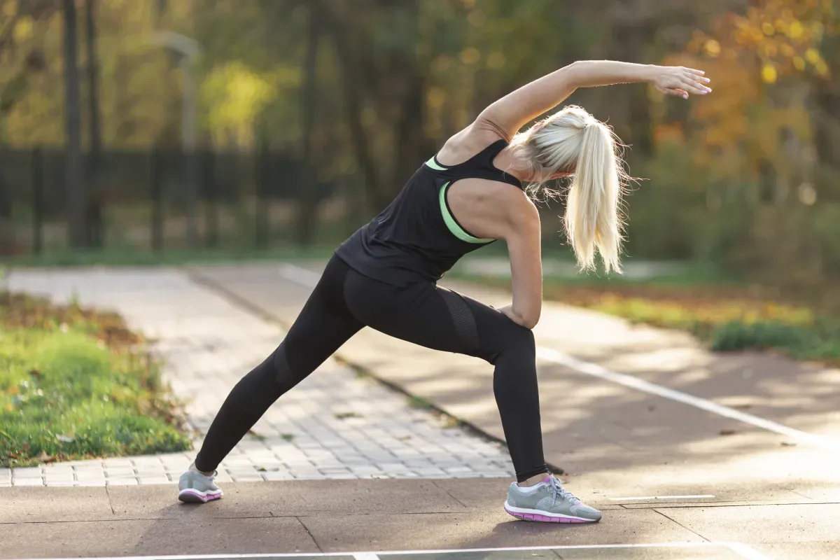 Person performing a deep squat mobility exercise in a gym