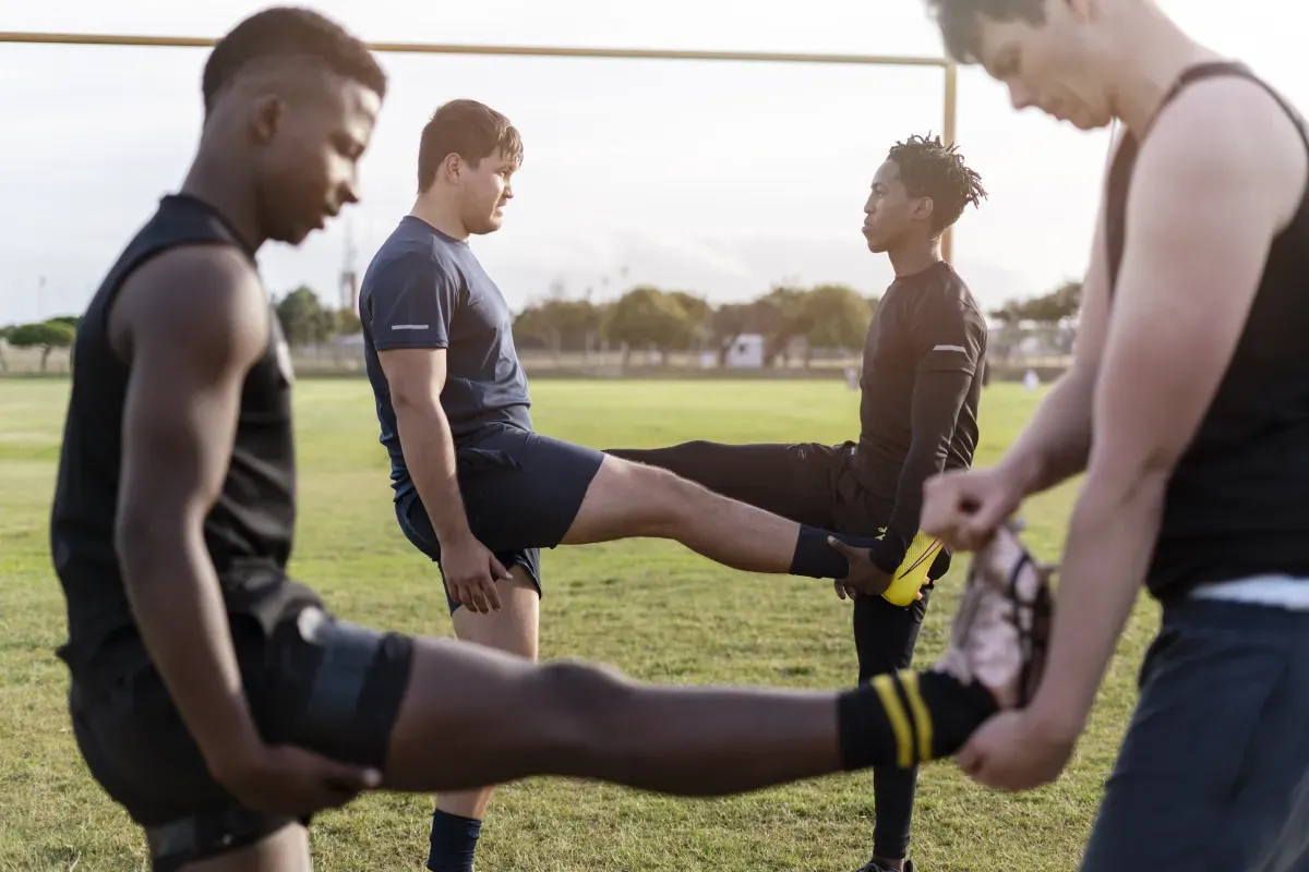 Football players training during pre-season on a grass pitch