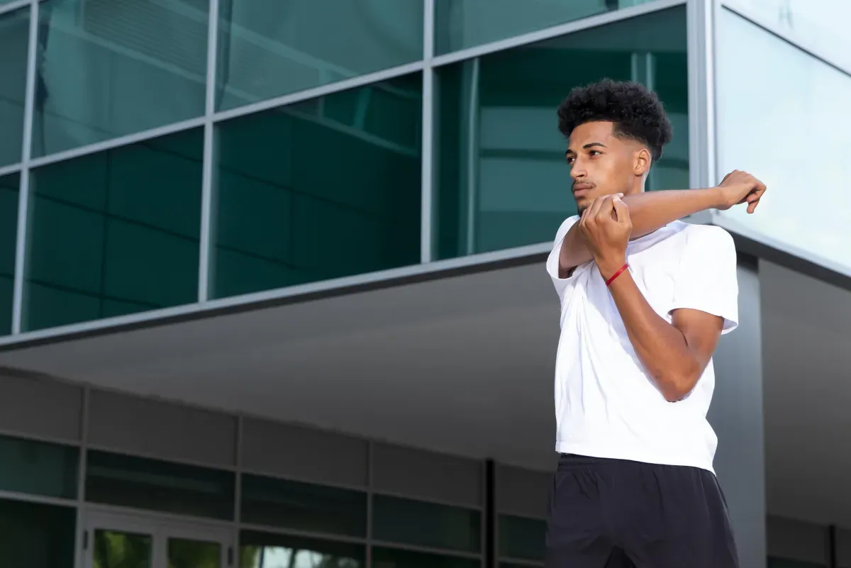 Athlete stretching on a sports field preparing for return to training