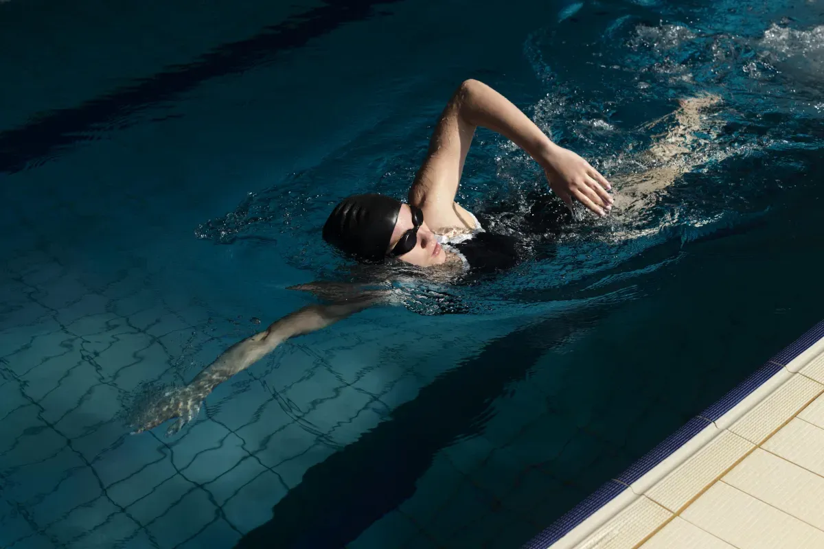 Swimmer doing freestyle stroke in a pool lane