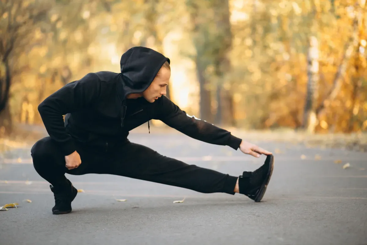 Athletes performing dynamic warm-up exercises on a sports pitch